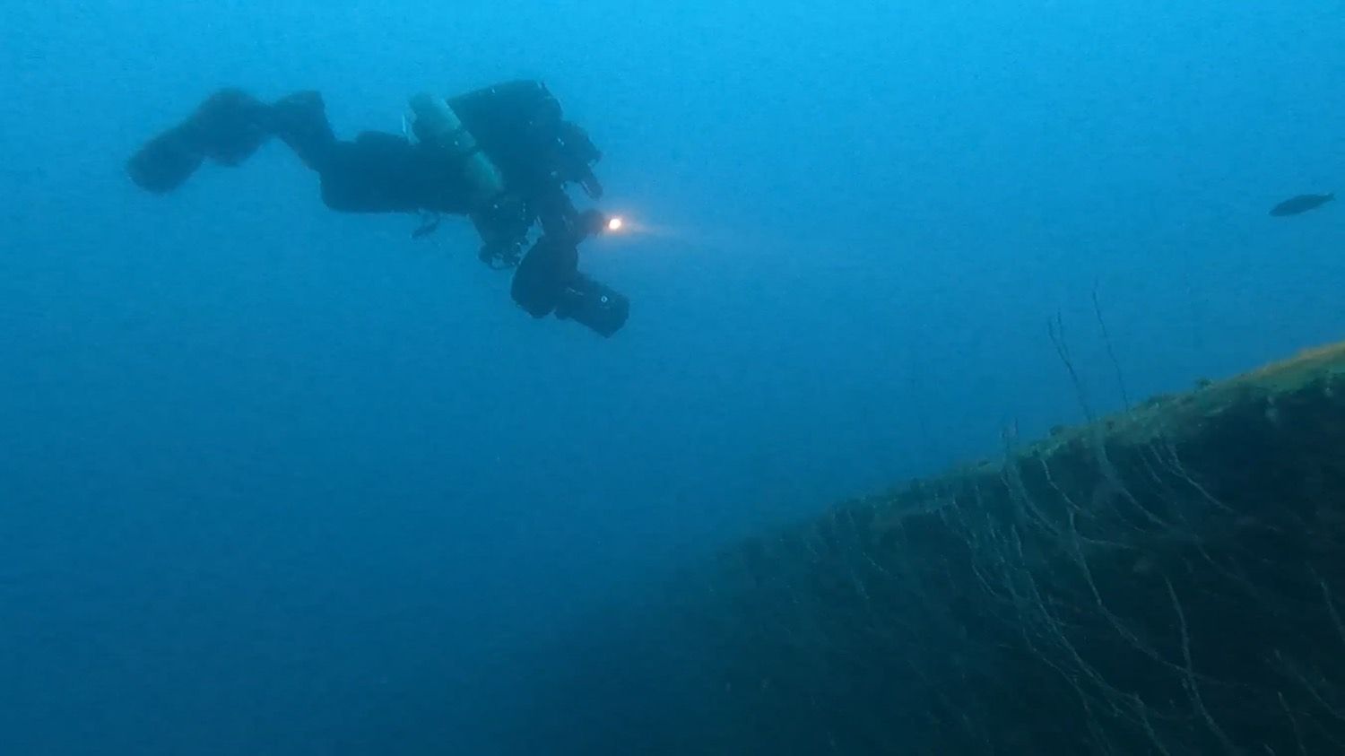 Technical diver descending the hull of the USS Arkansas at Bikini Atoll